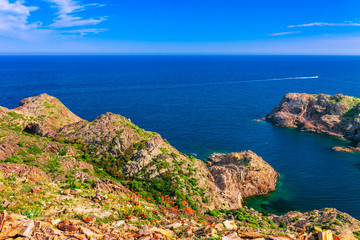 Sea landscape with Cap de Creus, natural park. Eastern point of Spain, Girona province, Catalonia. Famous tourist destination in Costa Brava. Sunny summer day with blue sky and clouds