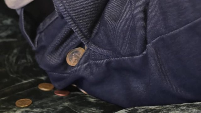Money lost simple concept - man loose coins from pocket - smooth zoom