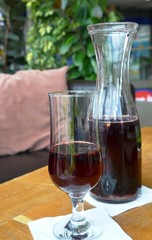 Fresh cold drink with blueberries in a glass on a wooden table