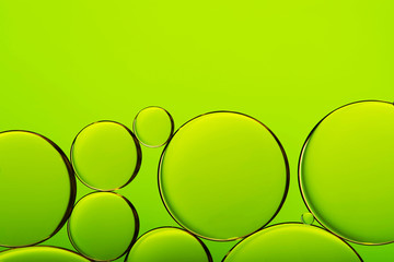 Oil drops in water, bubbles on green abstract background