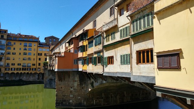 FLORENCE, ITALY - AUG 14, 2016: Arno river view with historic Ponte Vecchio bridge