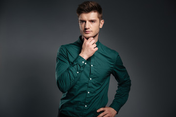 Fototapeta premium Handsome serious man dressed in shirt posing
