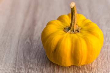 Fancy pumpkin on wooden table