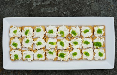 Goat cheese and garlic scape pesto mini toasts