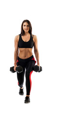 A sporty woman does the lunging of the legs with a dumbbell, legs in a half-position, hands along the torso on a white isolated background