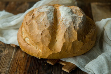 loaf of bread on wooden background, food closeup