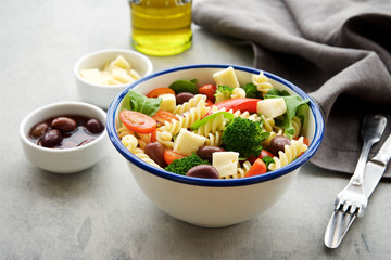 Pasta salad with vegetables and cheese. Concept of healthy eating, vegan food 
