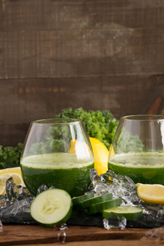 Whole body health with a a nutritious raw juice made with cucumbers and mint. Vertical image perfect for showing of healthy living, taking care of your skin and body from the inside out.