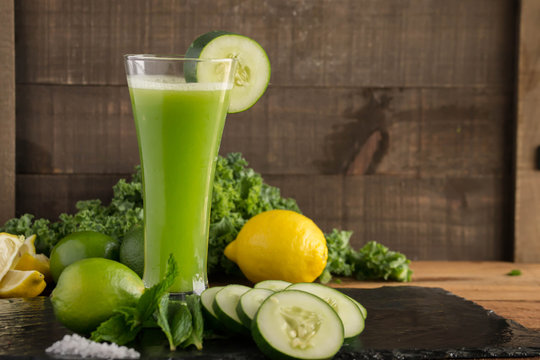 Juicing? Best green raw vegetable juice with cucumbers, mint, lemon and lime, and kale. Healthy and refreshing beverage.