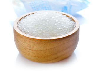 Silica gel in wood bowl on white background