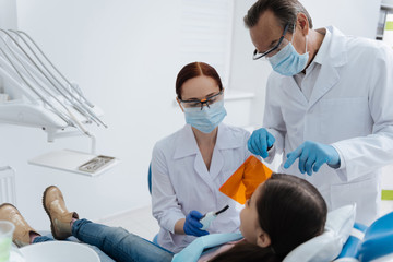 Fototapeta na wymiar Two dentists wearing sterile masks
