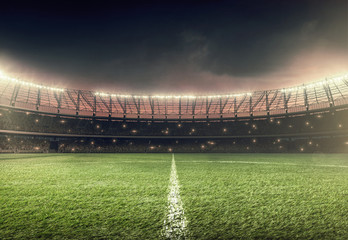 soccer stadium with green grass and illumination lights at night - obrazy, fototapety, plakaty