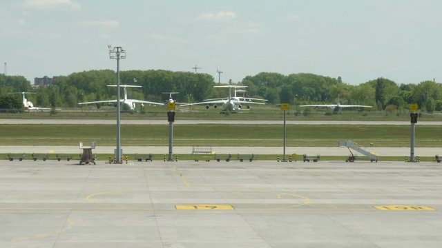 Parking of aircraft at the airport. There is a wind farm nearby