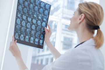 Qualified medical specialist analyzing radiograph at the laboratory