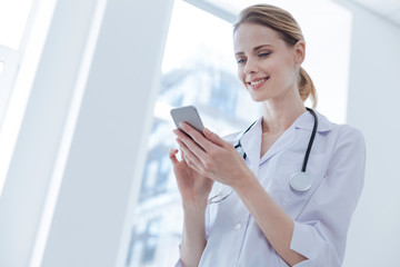 Charismatic therapist using digital gadget in the clinic