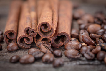 Coffee beans and cinnamon on wooden background. Top view.
