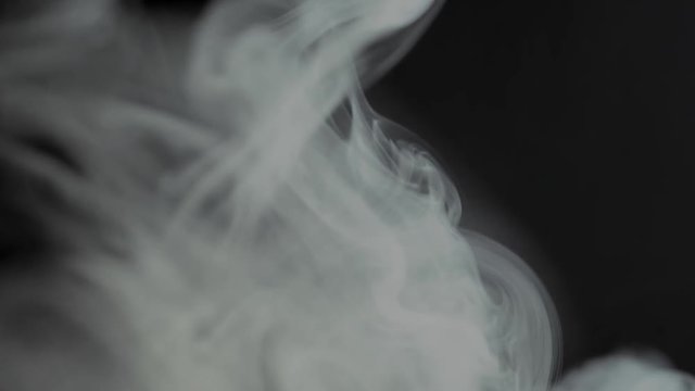 White cloud of cigarette smoke on black isolated background