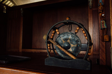 Asian authentic gong. Ancient percussion instrument gong. Asian gong drum black on a dark wood background