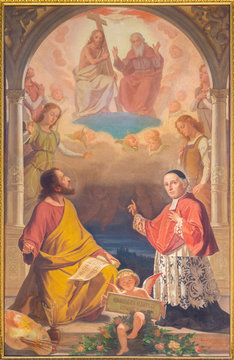 TURIN, ITALY - MARCH 13, 2017: The painting of St. Luke the Evangelist and St. Giuseppe Cottolengo with the Holy Trinity in Duomo by Luigi Guilielmino (1920).