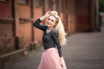 A beautiful girl is walking along the street.