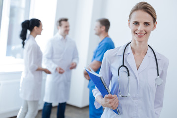 Pleasant doctor enjoying working hours at the clinic