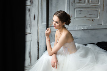 Portrait of a beautiful bride. Bride's fees in the studio