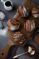 Chocolate cookies of  Woopie  Cookie with mascarpone cream on a gray dark concrete background. Selective focus. Top view. Space for text.