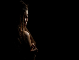 woman body contour on a dark background. female face and neck scape. free space for text