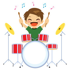 Cute young little boy happy playing drums