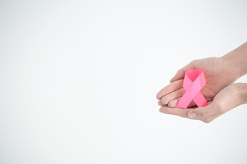 Hands holding pink ribbon