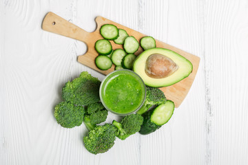 Green smoothie from broccoli, avocado and cucumber with ingredients