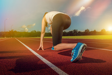 Sport Runner woman on stadium track. Fitness and workout wellness concept.