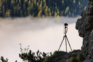 Camera silhouette above sea of clouds