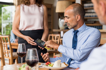 Businessman swiping credit card