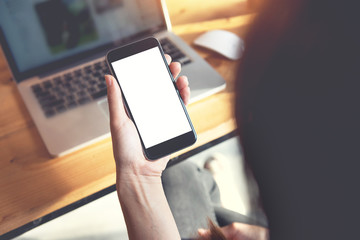 Close up of women's hands holding smart phone with blank copy space white screen for create content.