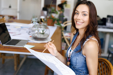 Young woman standing in creative office