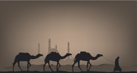 Camels in the desert against the background of the mosque.