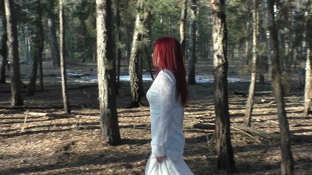 Woman is walking in the autumn forest.