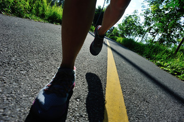 healthy lifestyle woman runner running on morning tropical forest trail