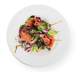Restaurant food closeup - salad with prosciutto and vegetables