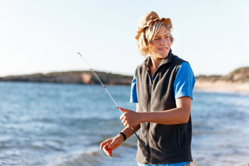 Teenage boy fishing at sea