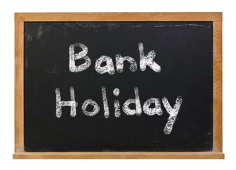 Bank Holiday written in white chalk on a black chalkboard isolated on white