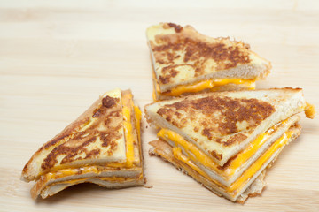 bread with egg and cheese on wooden table