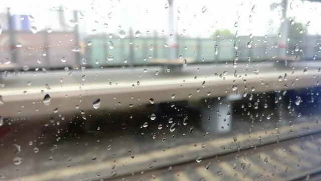 rain drops on the window of a moving train