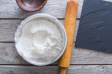 Baking concept. Flour and rolling pin on wood
