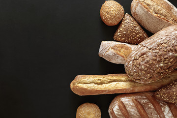 Bakery concept. Plenty of bread background isolated on balck