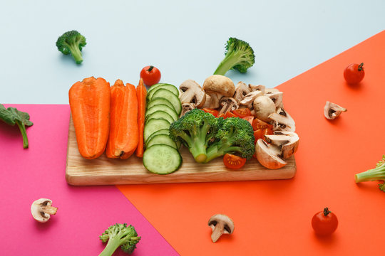 Cut raw vegetables on wooden board, healthy food