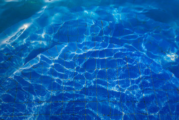 water in swiming pool with sun reflections use for background