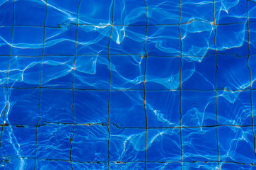 water in swiming pool with sun reflections use for background