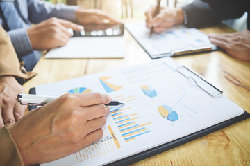 Business concept. Business people discussing the charts and graphs showing the results of their successful teamwork.